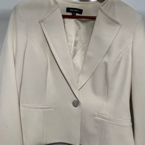 White fully lined suit jacket with small stains on sleeves and pocket area